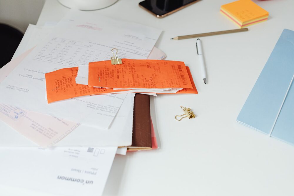 Stack of invoices and financial documents organized for bookkeeping