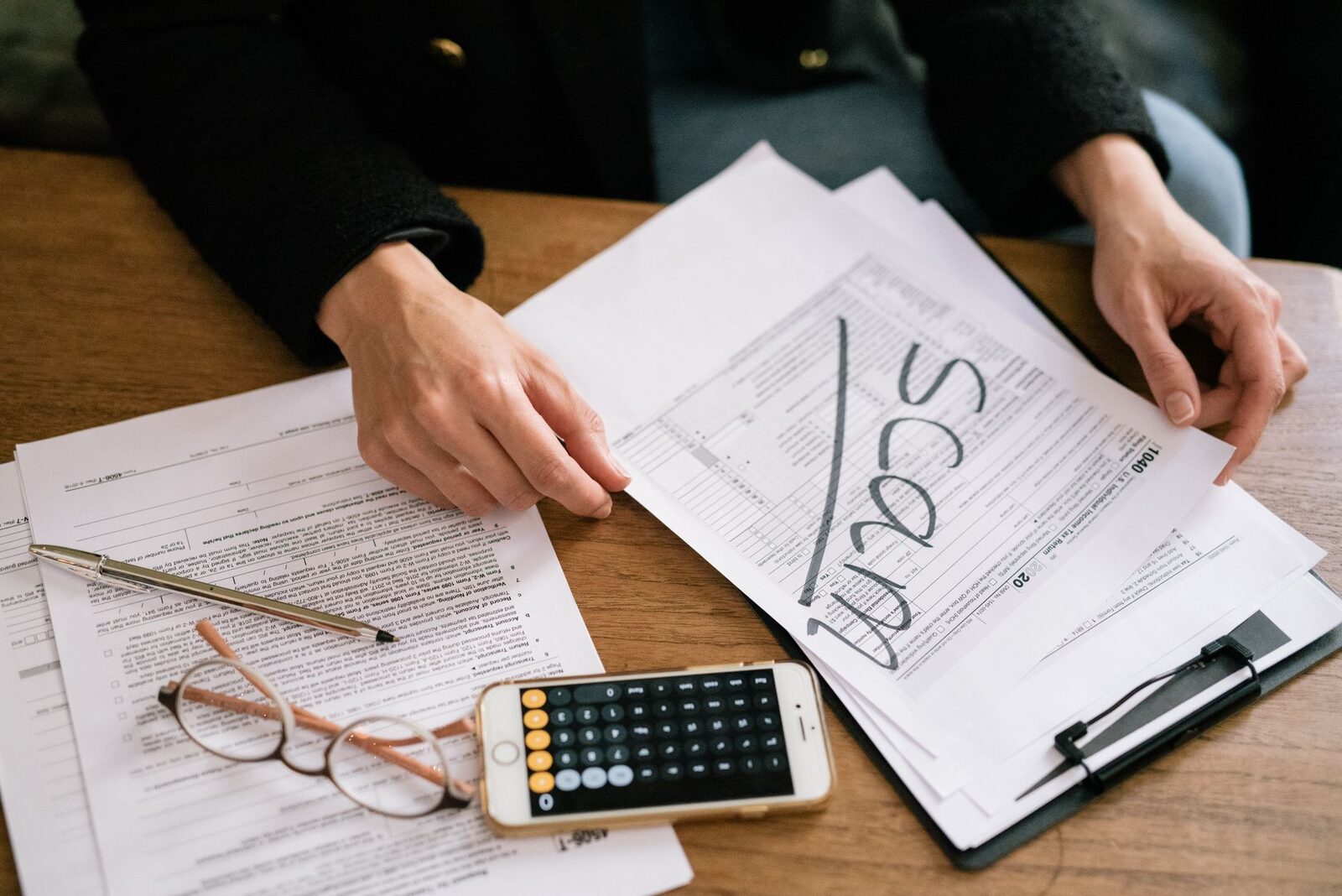 Canadian tax forms, ledgers, and paperwork on a CPA firm desk in Edmonton