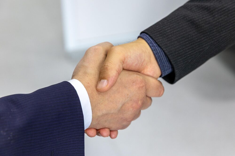 Financial advisor shaking hands with a new client in Edmonton