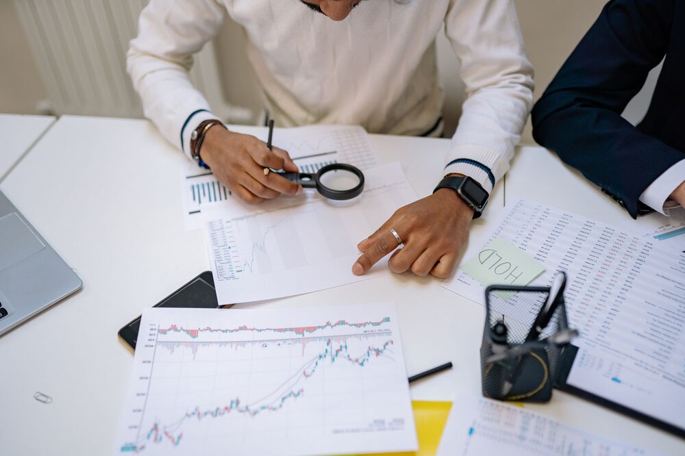 Financial planner reviewing a retirement plan with documents and a laptop