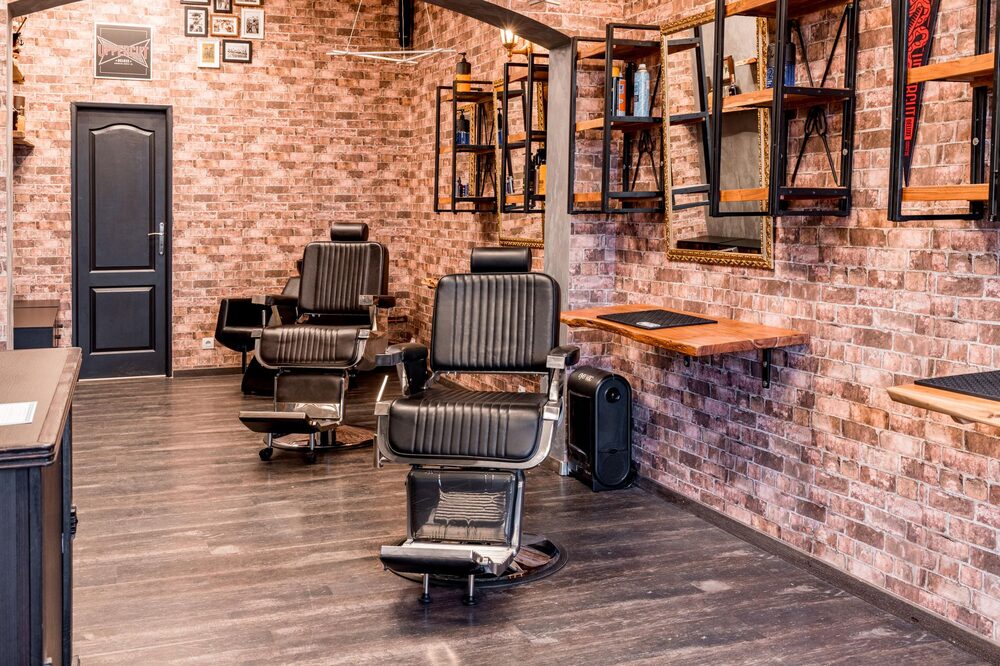 Barber giving a precise fade haircut in an Edmonton barbershop