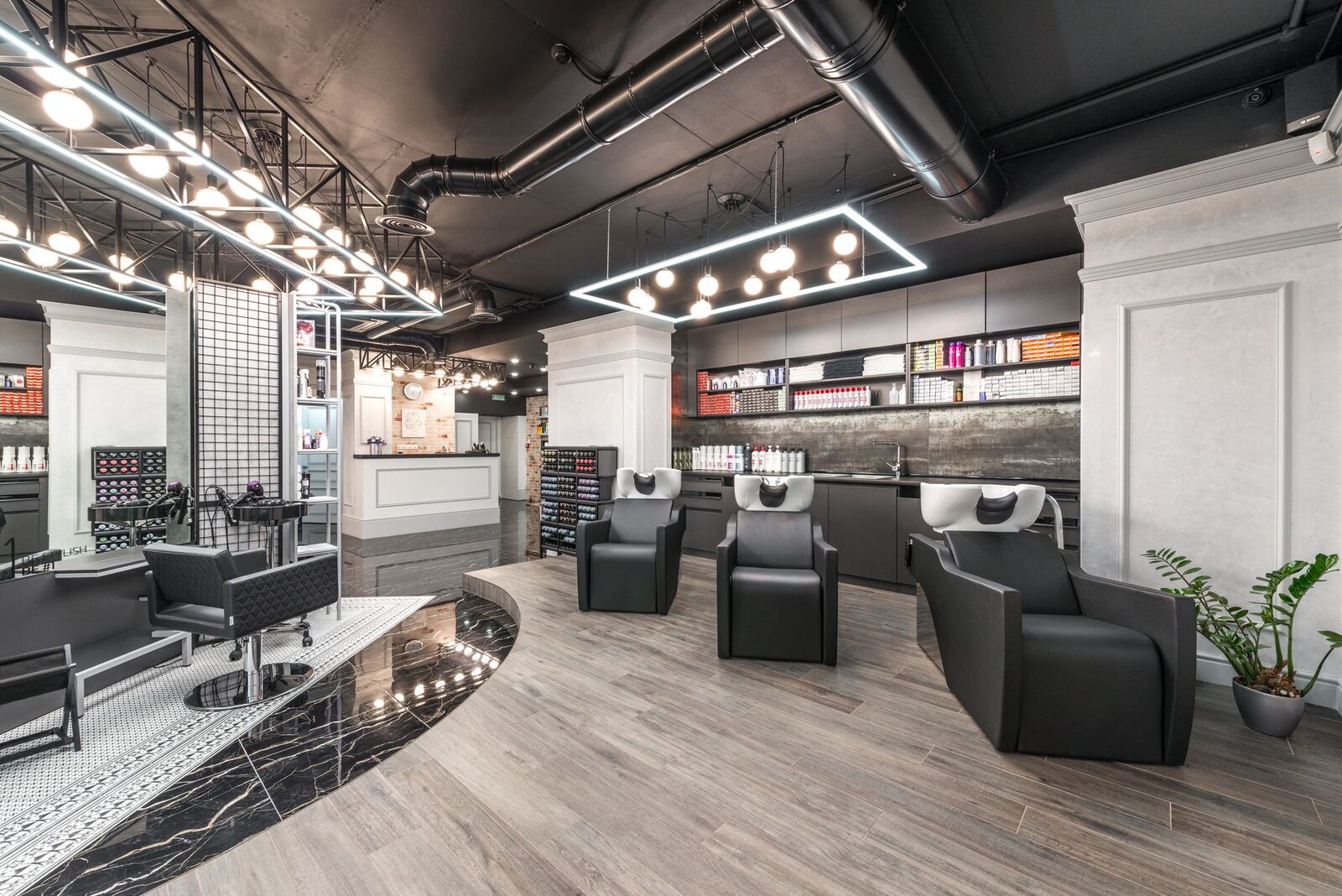Stylist finishing a balayage colour in a modern Edmonton hair salon