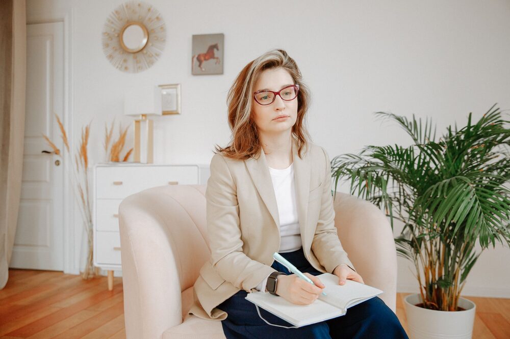 Therapist and client in a warm, confidential counselling session